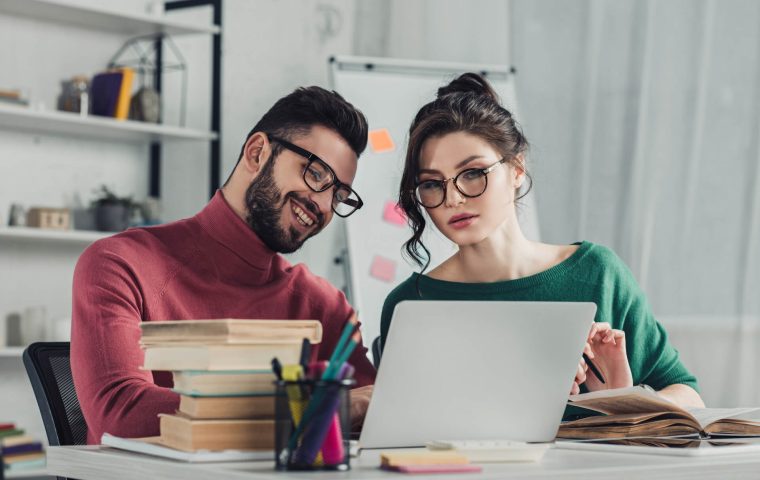 cheerful-man-in-glasses-sitting-near-female-collea-2022-02-06-04-53-29-utc.jpg